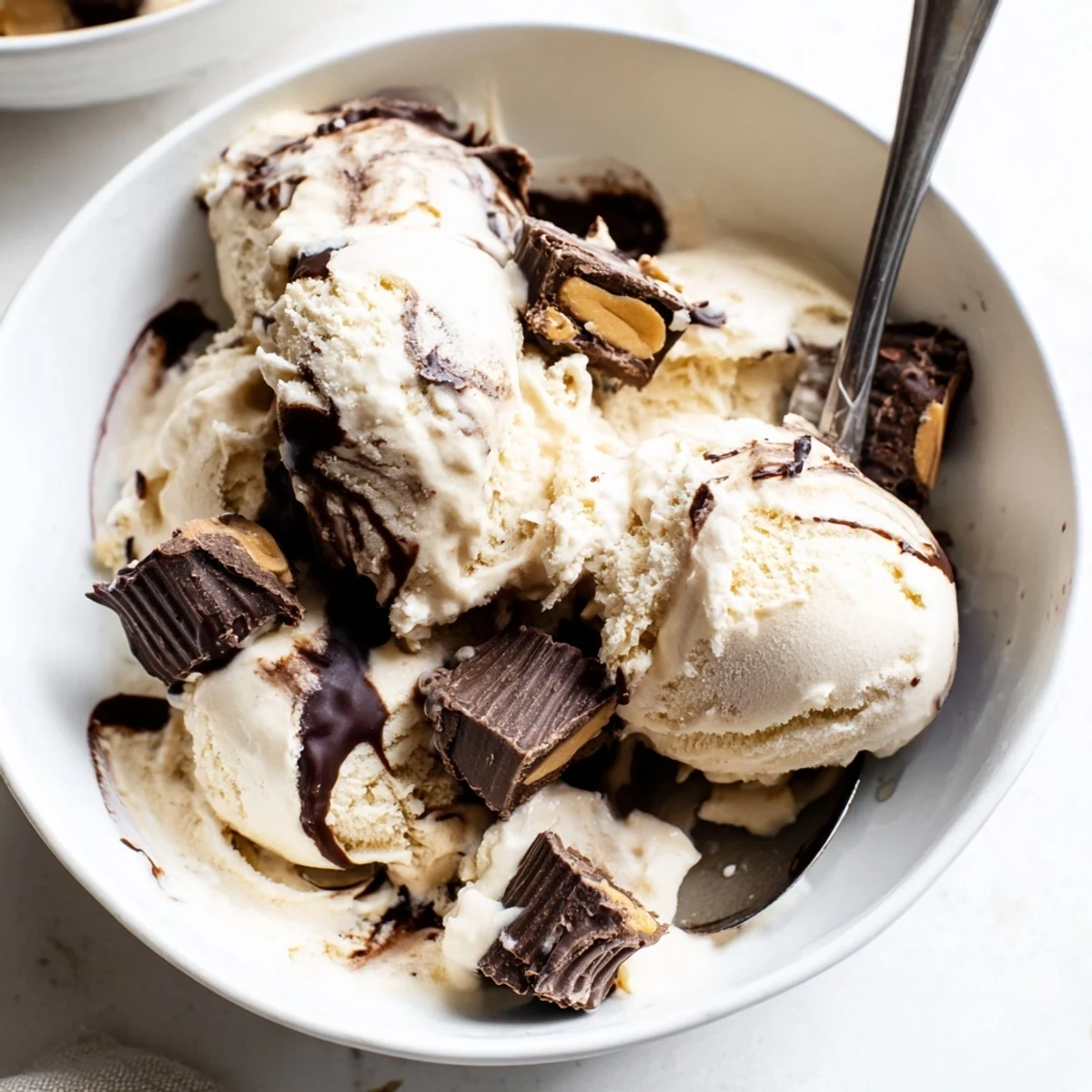 Frozen homemade Moose Tracks dessert featuring gooey fudge swirl and chocolate candy pieces