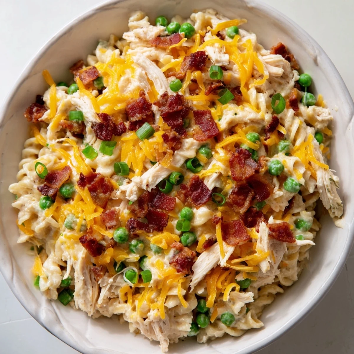 Slow cooker crack chicken casserole loaded with tender pasta, ranch seasoned shredded chicken and golden cheese layers