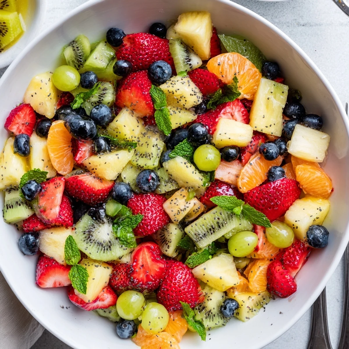 Refreshing spring Easter fruit salad featuring vibrant mixed tropical fruits drizzled with honey lime dressing