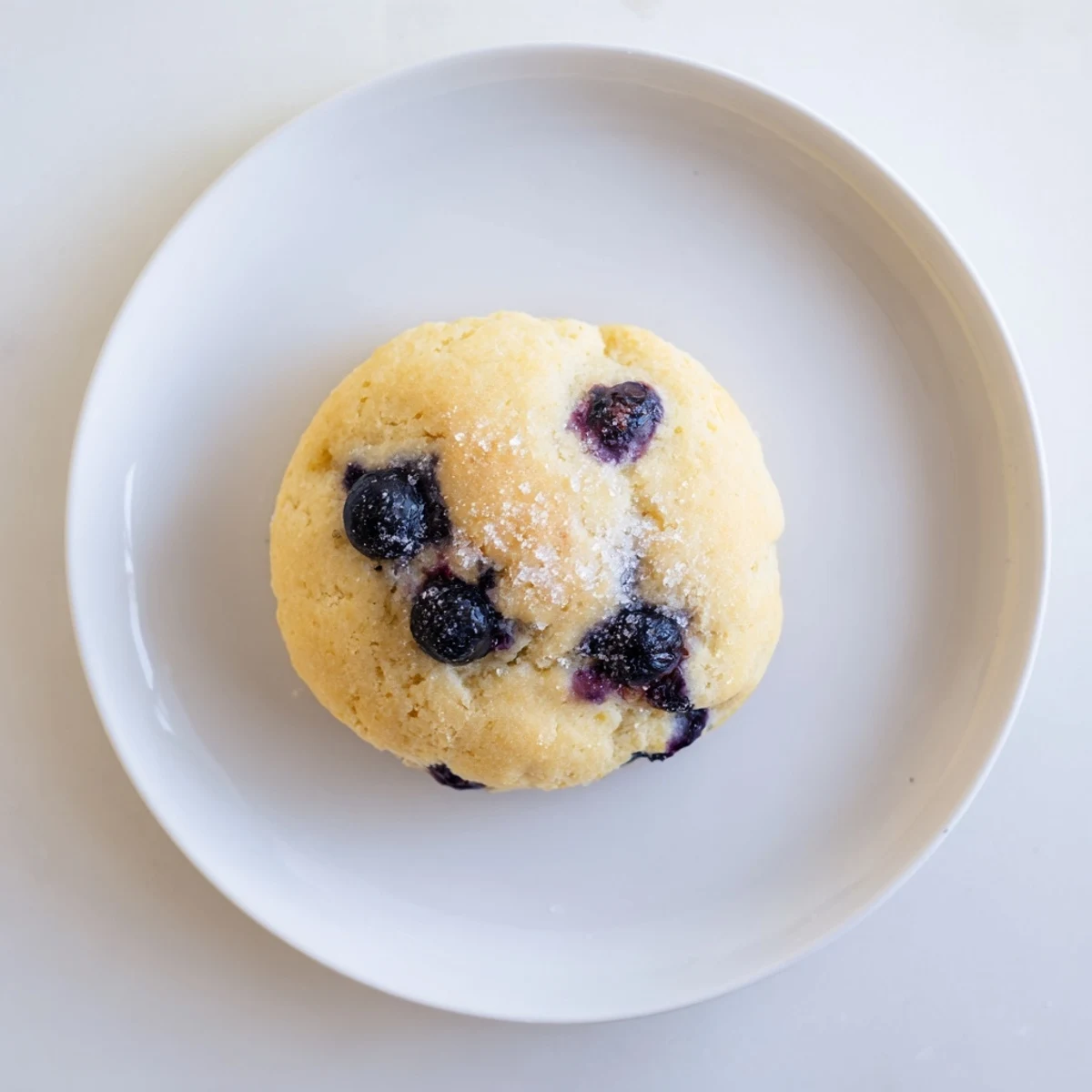 Golden blueberry biscuits fresh from the oven with scattered sugar on top