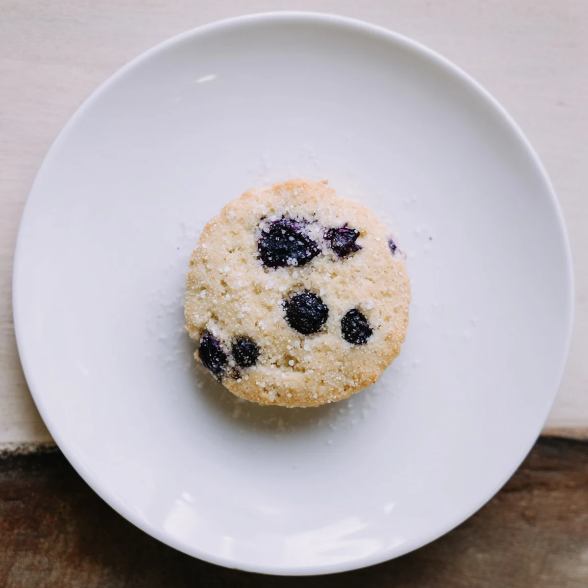 Tender homemade blueberry biscuits with juicy berries peeking through golden layers