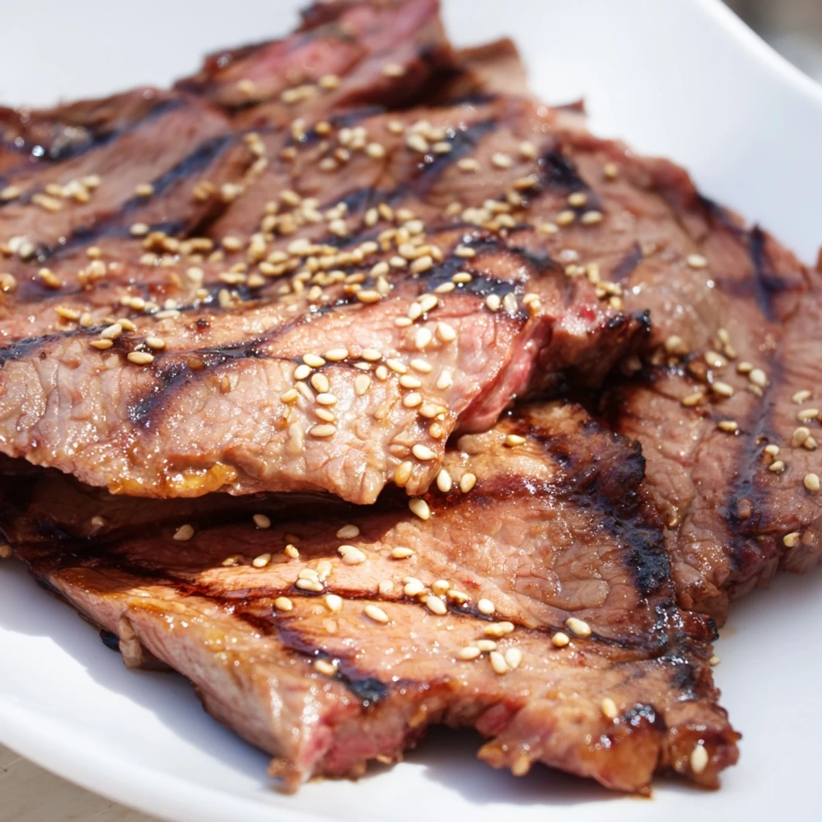 Sizzling beef yakiniku with glossy caramelized edges served over steamed white rice