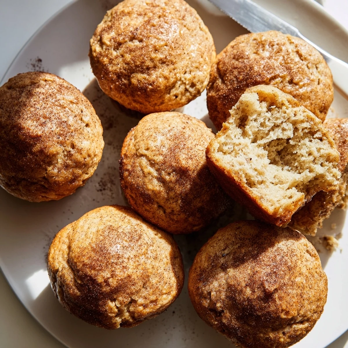 Golden-topped banana muffins cooling on a wire rack, perfect for a quick breakfast
