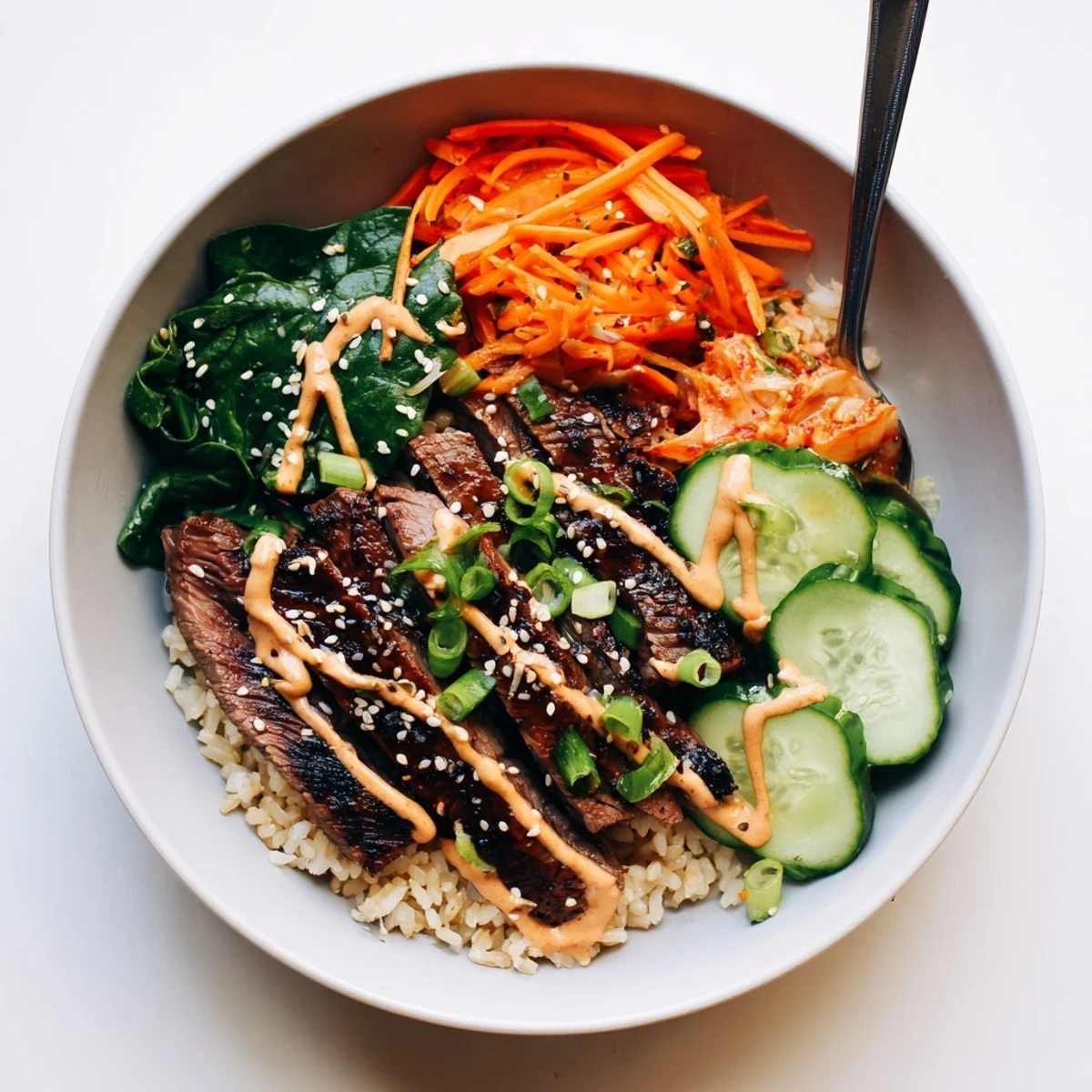 A vibrant Korean BBQ steak rice bowl garnished with sesame seeds and kimchi
