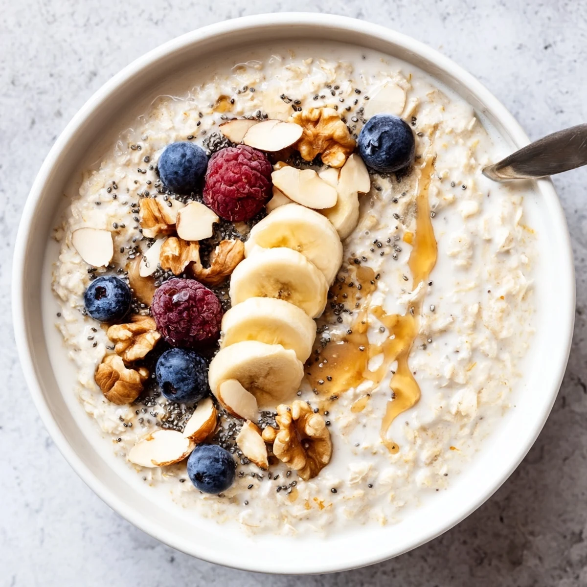 Warm vanilla Protein Oatmeal steaming in bowl, drizzle of maple syrup