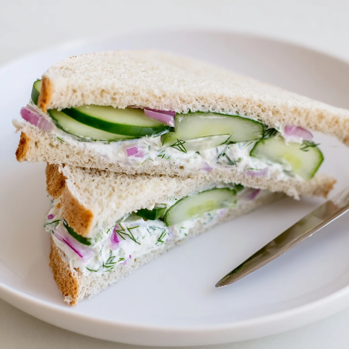 Chilled, creamy dill and Greek yogurt mix between soft slices: Quick Cucumber Salad Sandwiches