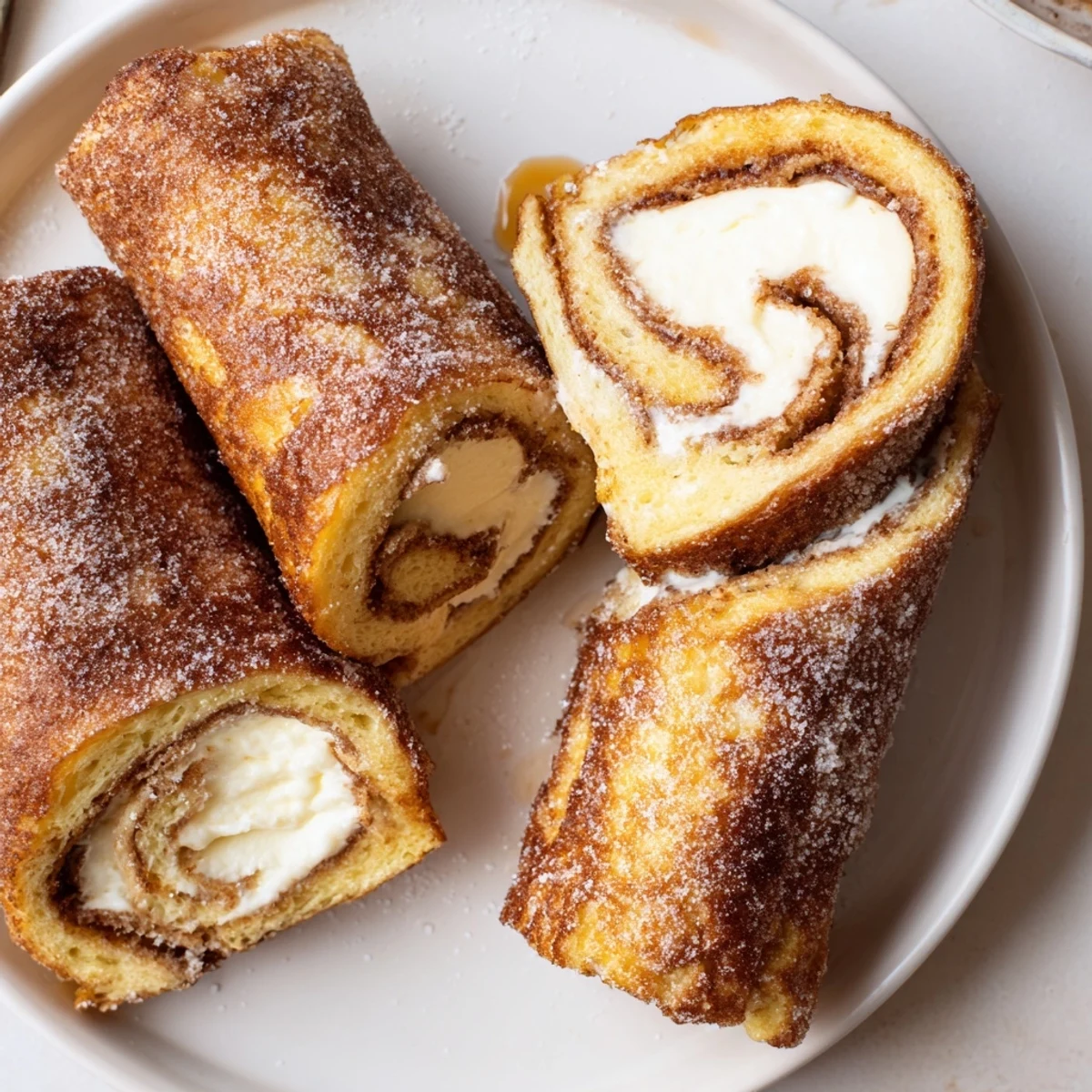 Cinnamon Roll French Toast Roll Ups, golden-crisp, cream cheese filled, served warm.