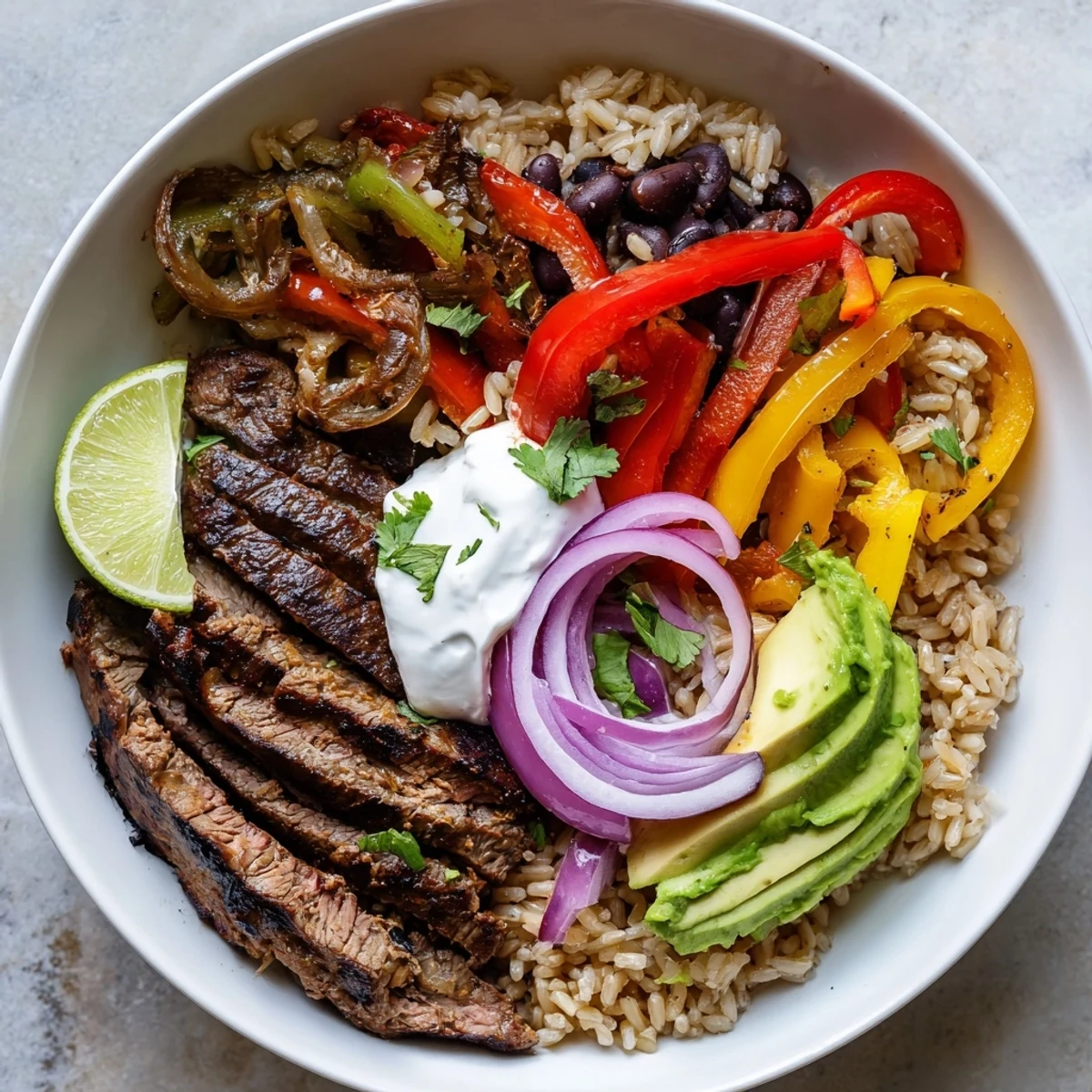 Comforting Steak Fajita Power Bowls served with creamy avocado, warm brown rice