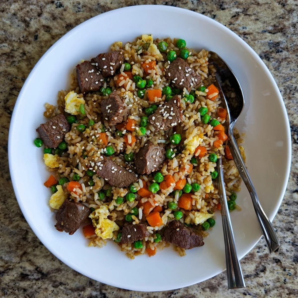 Blackstone Hibachi steak fried rice featuring tender beef cubes, colorful vegetables, and fluffy grains