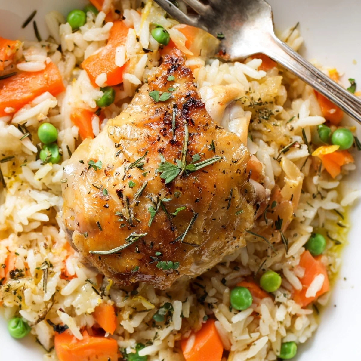 Family-style Slow Cooker Lemon Herb Chicken And Rice served hot with fork