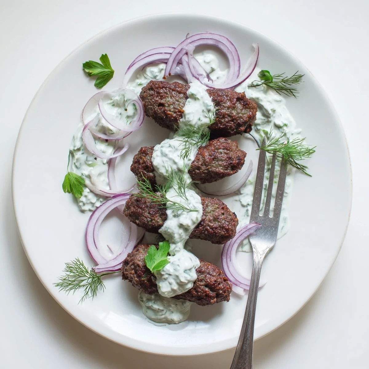 Middle Eastern smashed kebabs featuring juicy spiced beef topped with refreshing yogurt dressing