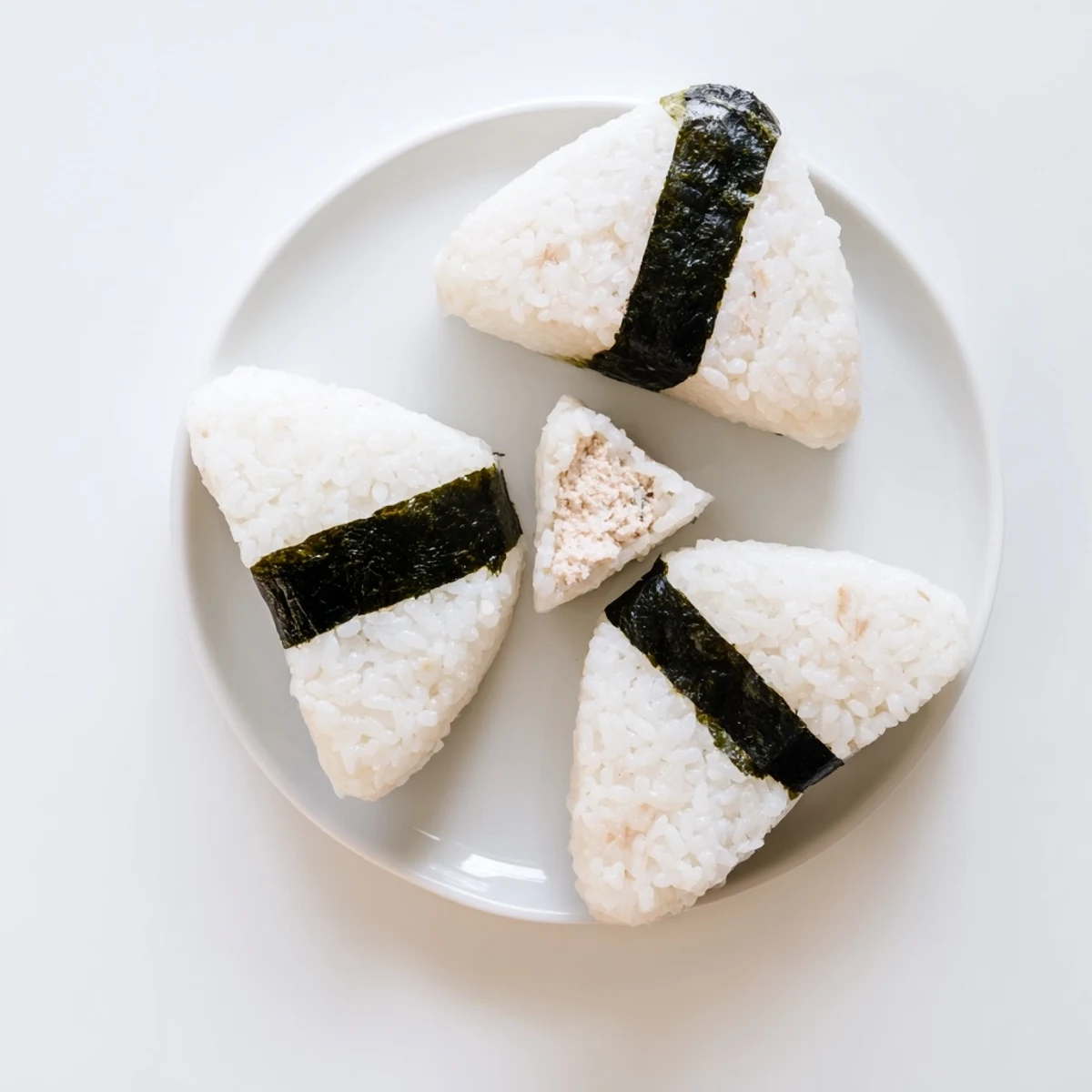 Creamy tuna filled rice ball onigiri garnished with black nori seaweed