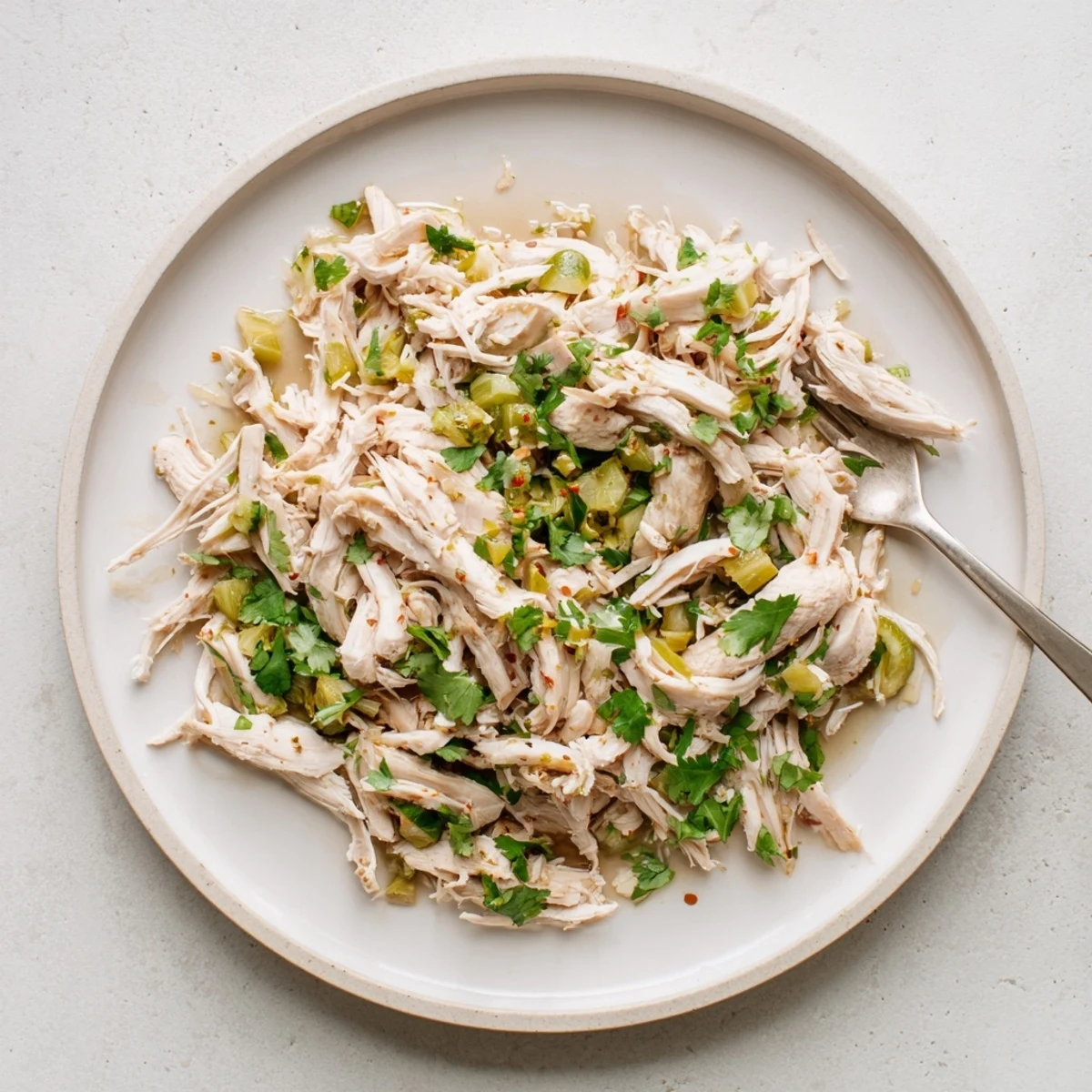 Slow Cooker Cilantro Lime Chicken shredding in juices, bright cilantro and lime aroma