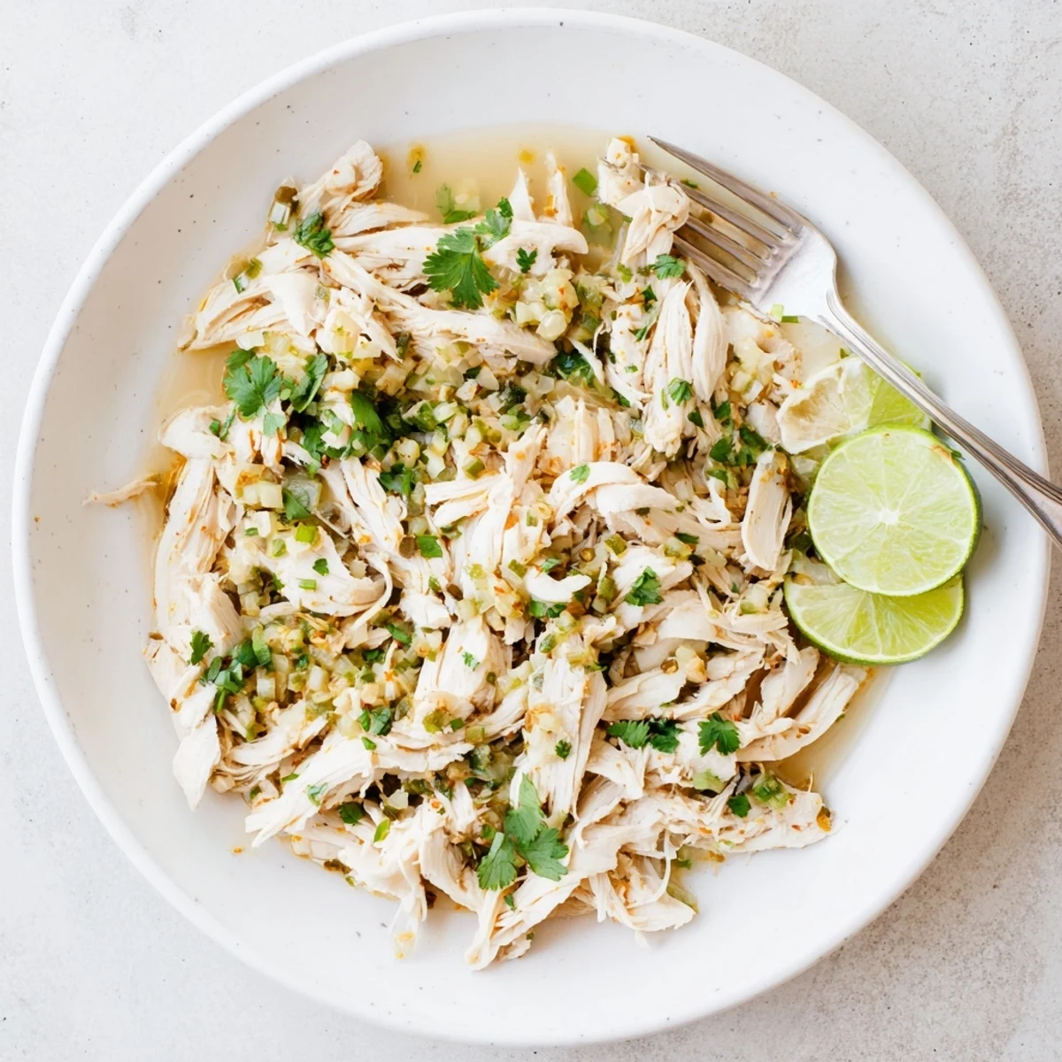 Fork-tender, tangy Slow Cooker Cilantro Lime Chicken wrapped in warm corn tortillas