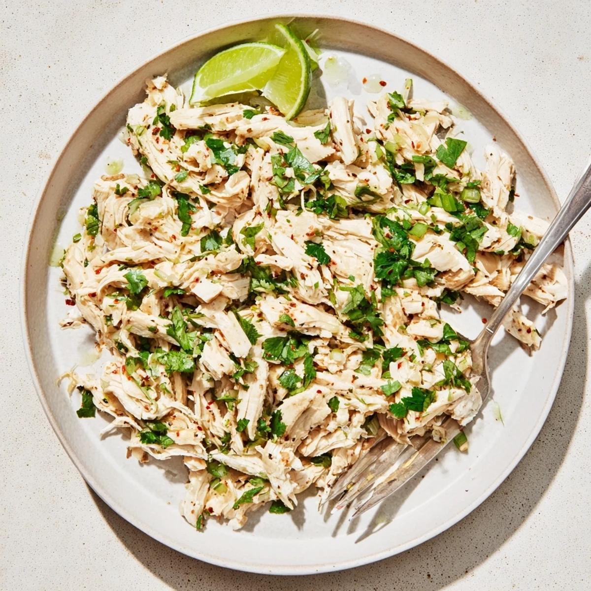 Warm bowl of rice topped with Slow Cooker Cilantro Lime Chicken and cilantro