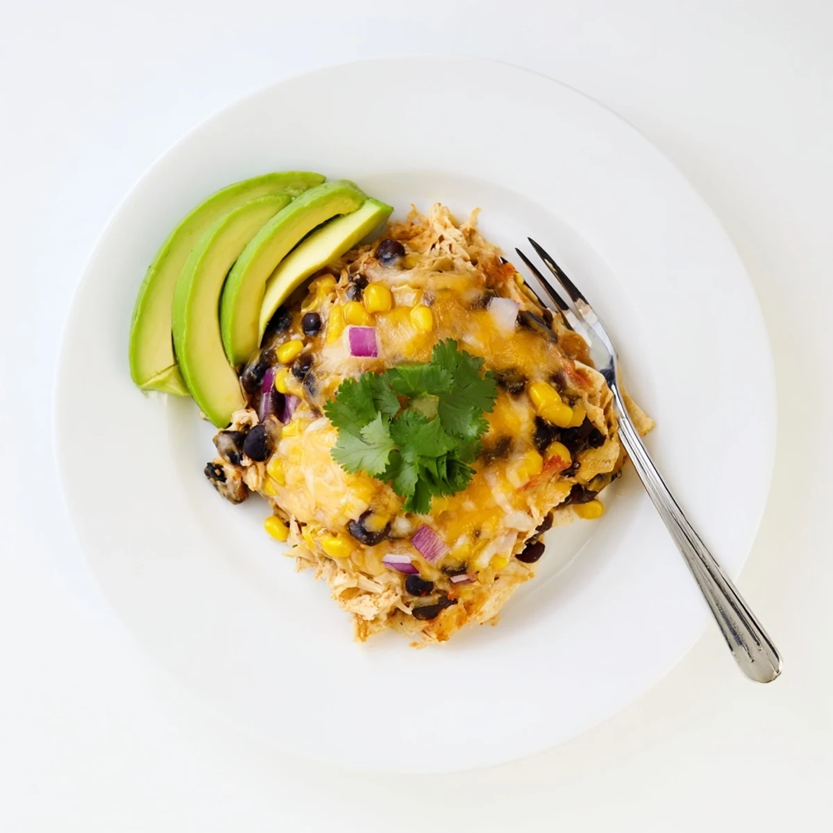 Warm Salsa Verde Chicken Casserole served family-style with lime wedges and cilantro