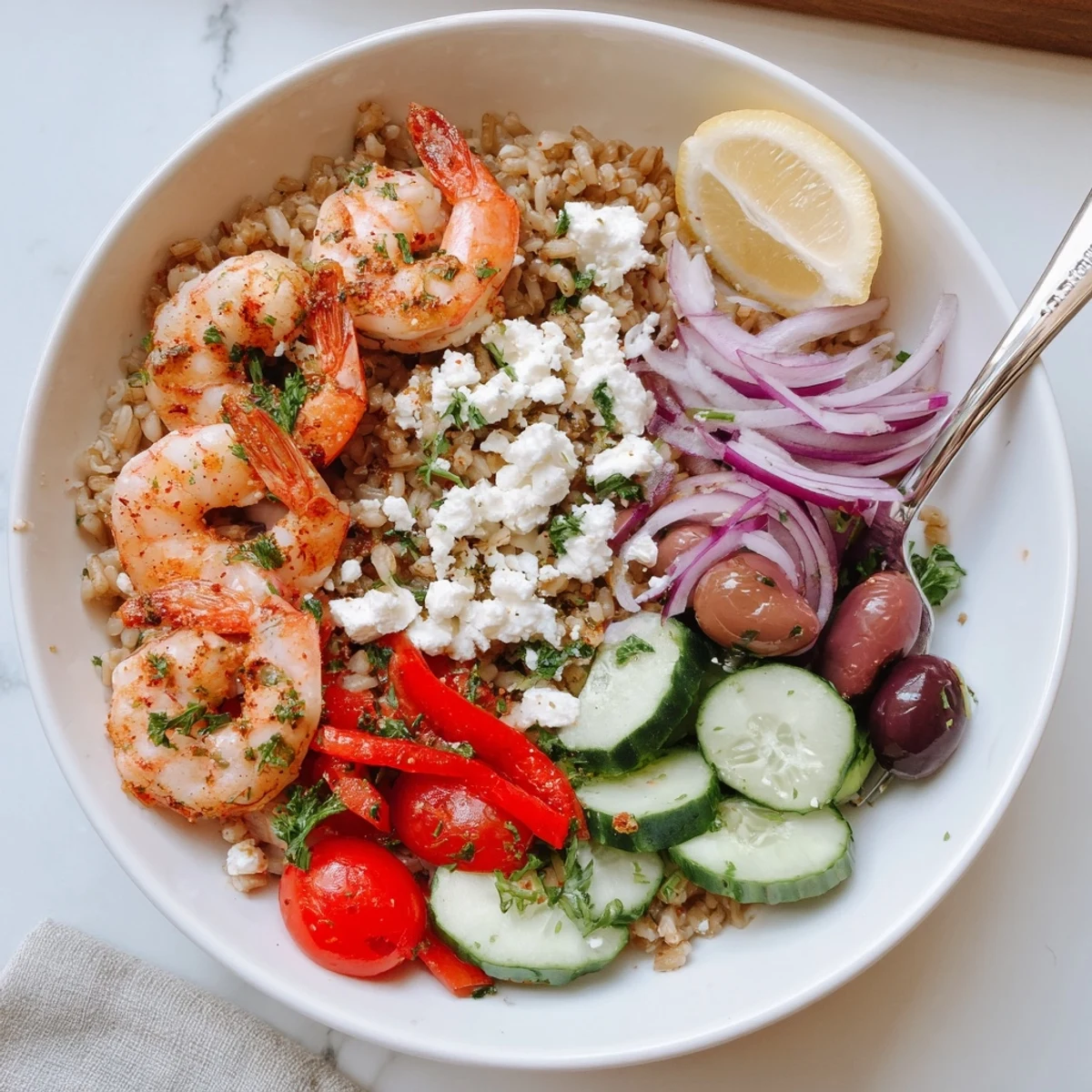 Sizzling Greek shrimp Mediterranean bowl loaded with olives, roasted peppers, and crumbled feta cheese